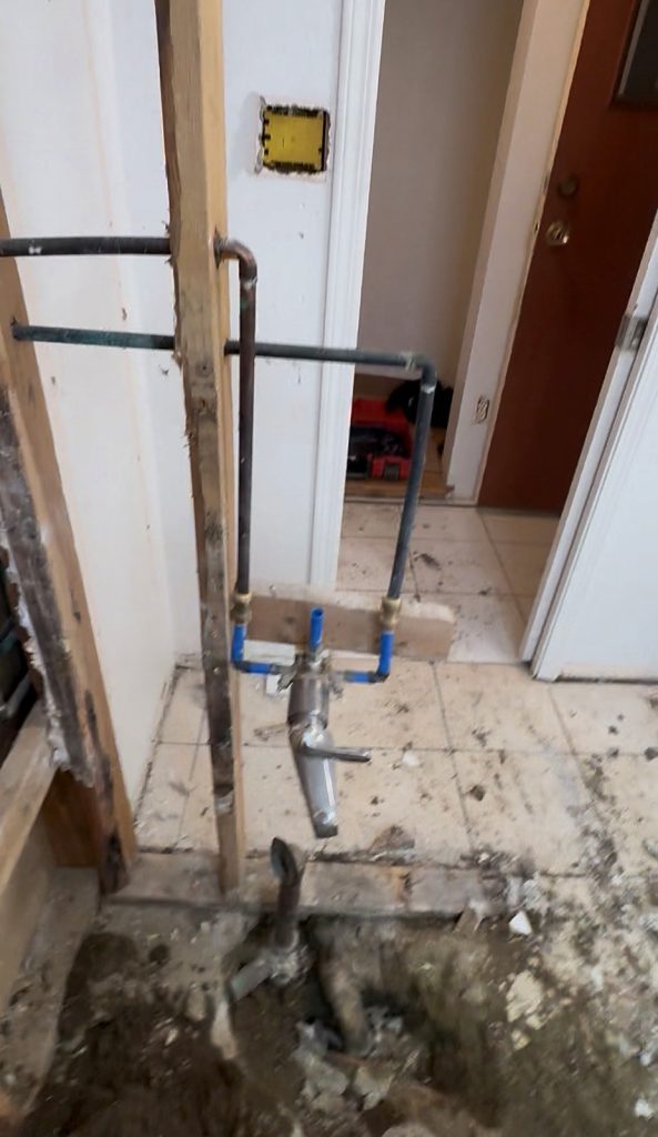 Old bathroom plumbing exposed during demolition Vancouver BC renovation