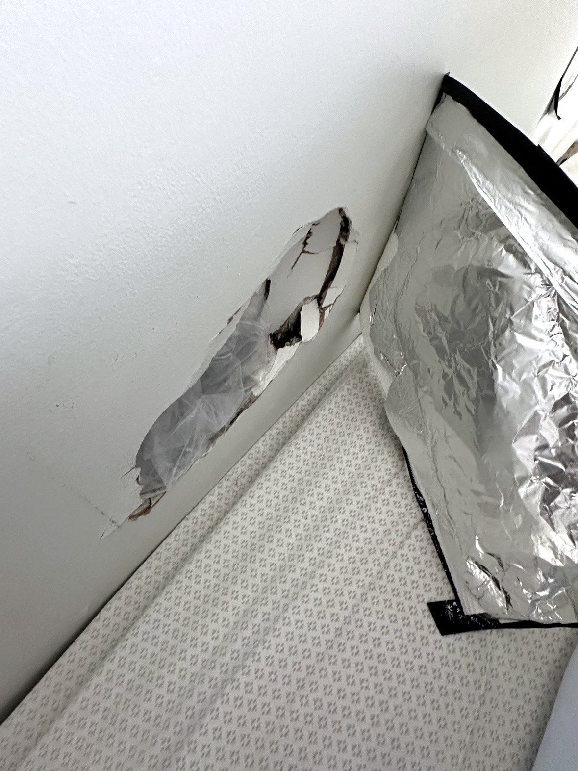 Damaged drywall wall with long gash before repair in Vancouver home
