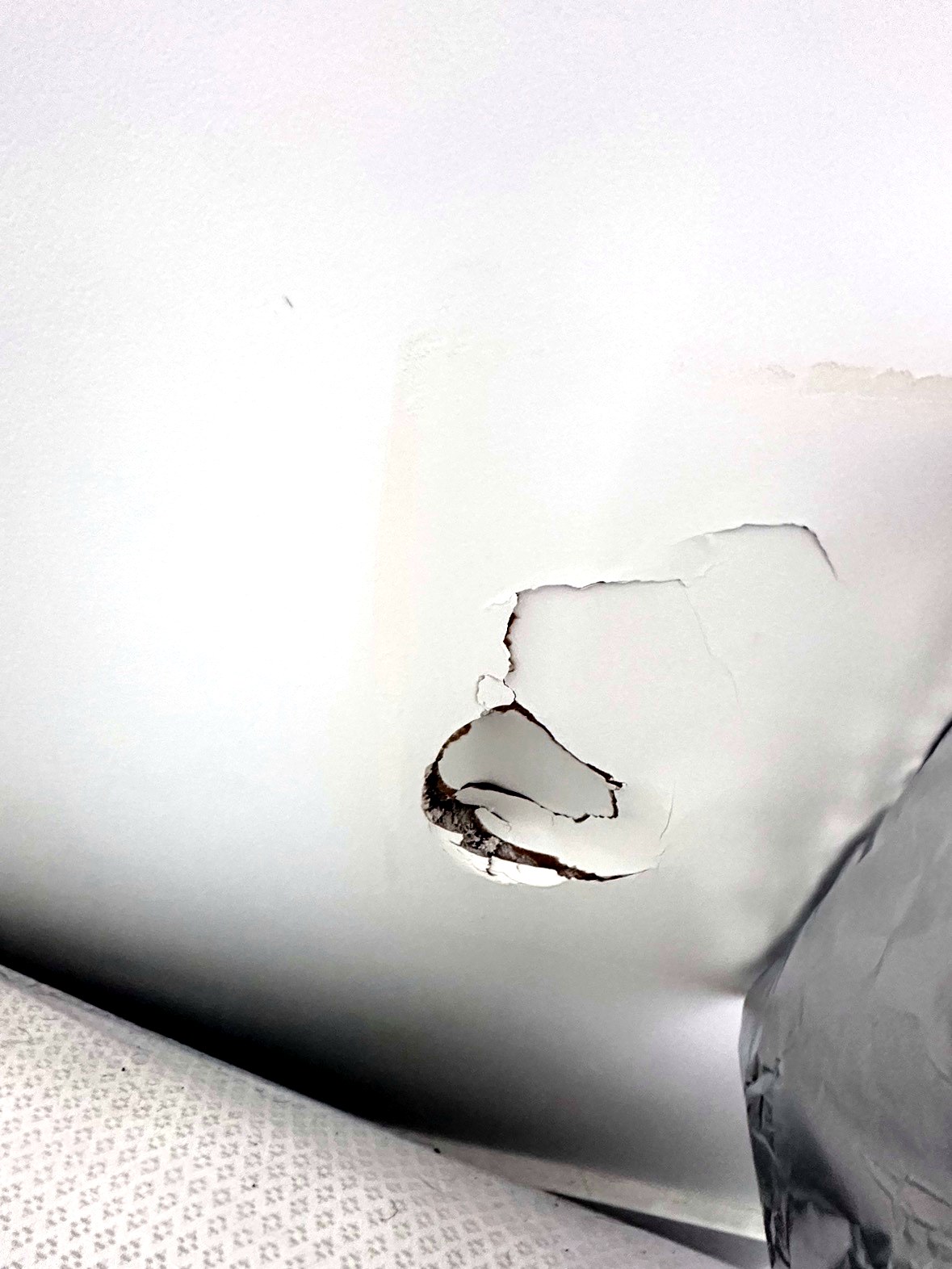 Punched hole in drywall wall before repair Vancouver BC