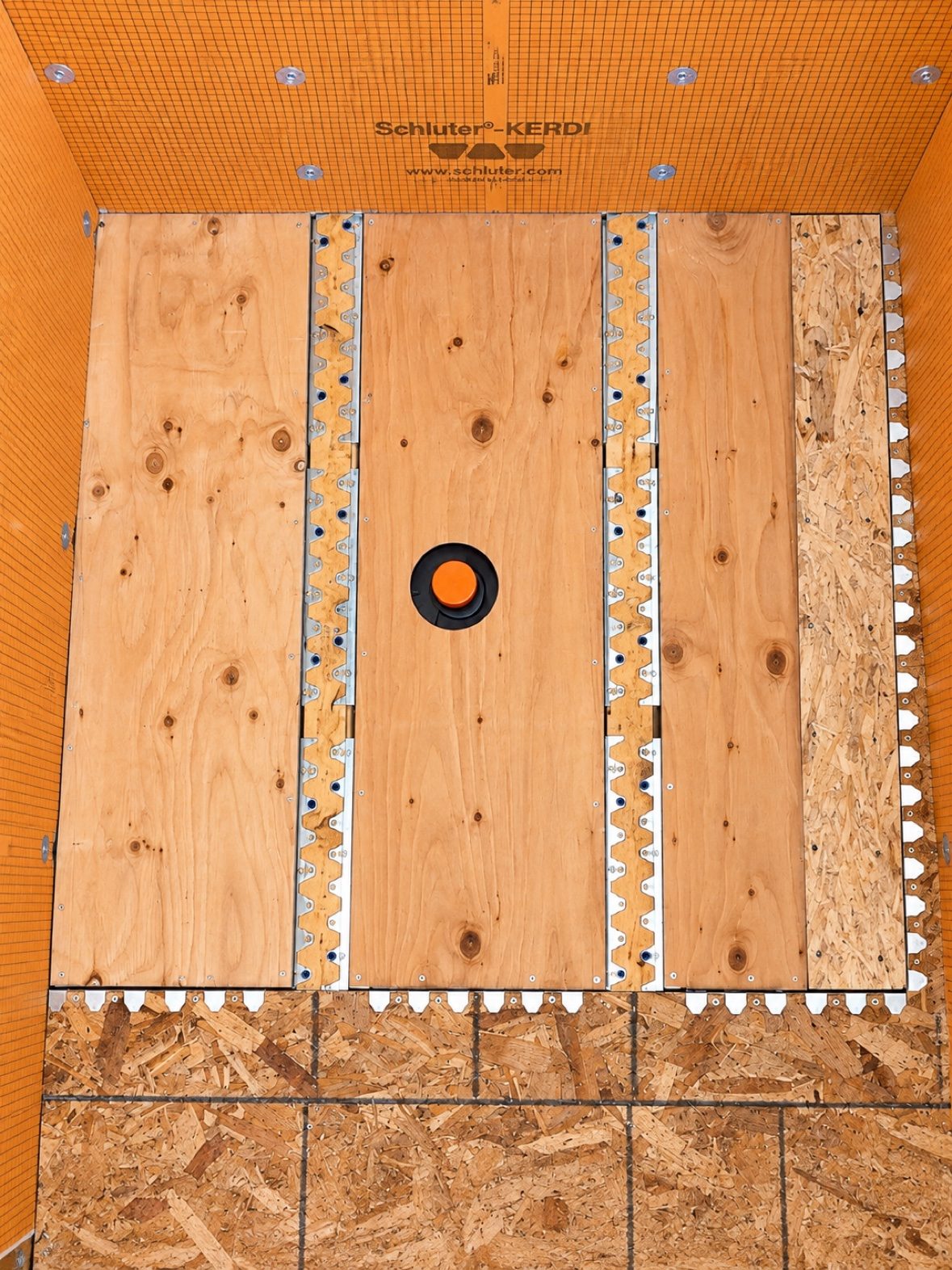 Recessed subfloor framing during a curbless shower build in West Vancouver