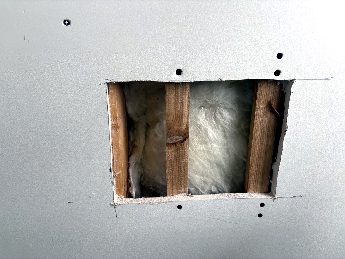 Wood backing installed behind drywall opening for patch support