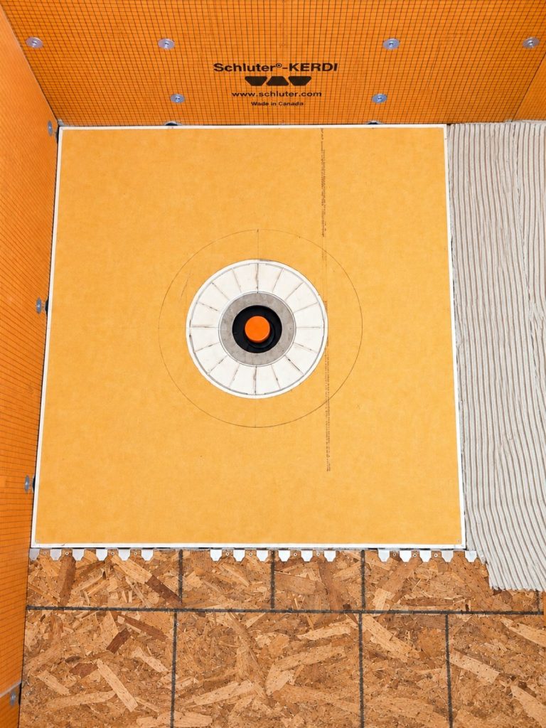 Schluter KERDI-SHOWER tray set into the recessed floor for a level-entry shower