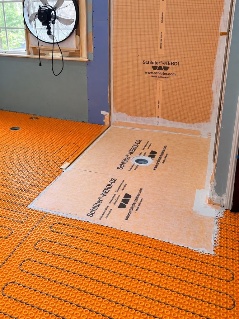 Schluter KERDI waterproofing and DITRA-HEAT heated floor cables during West Vancouver bathroom renovation