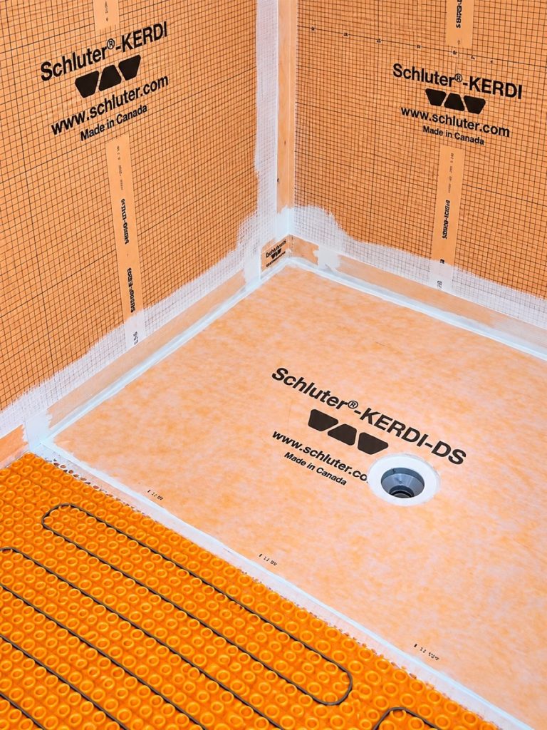 Waterproofed shower corner with KERDI membrane and sealed seams