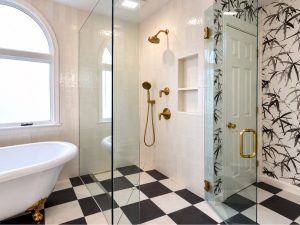 Finished West Vancouver bathroom with freestanding clawfoot tub with gold feet and curbless glass shower