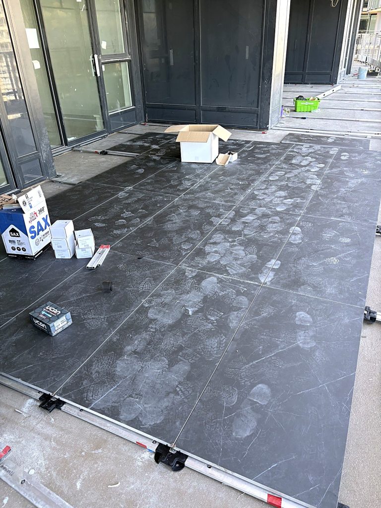 Large format balcony tiling in progress Burnaby BC