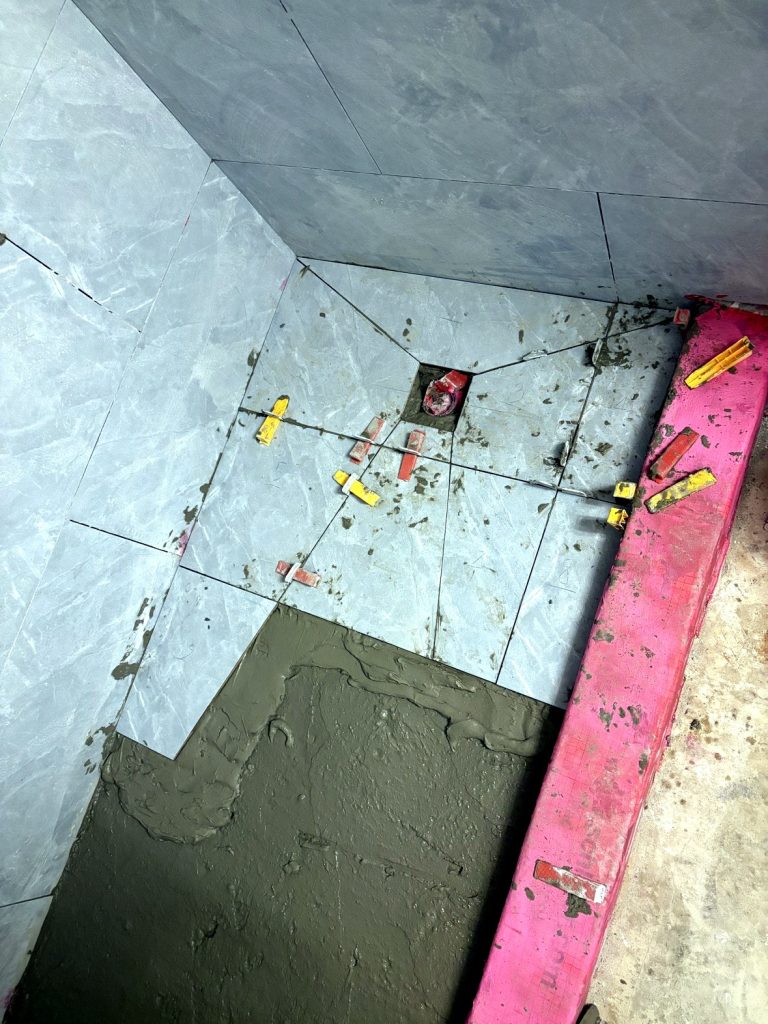 Walk-in shower floor tiling with leveling clips Langley