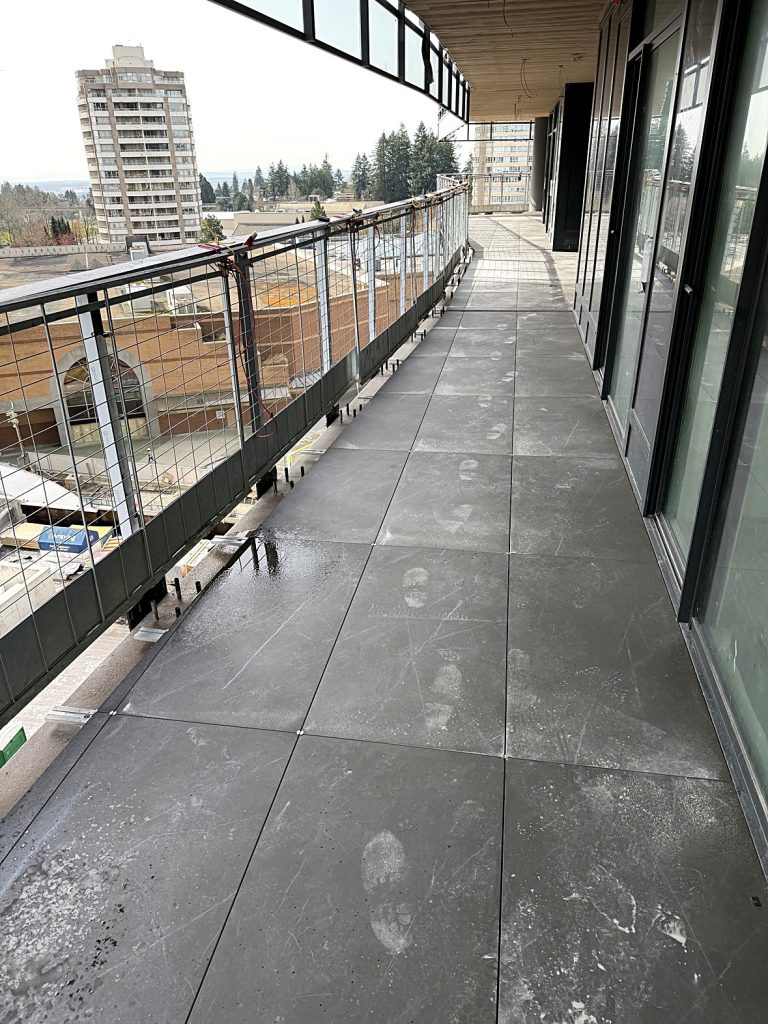 Large format 24x48 balcony tiles installed Burnaby BC
