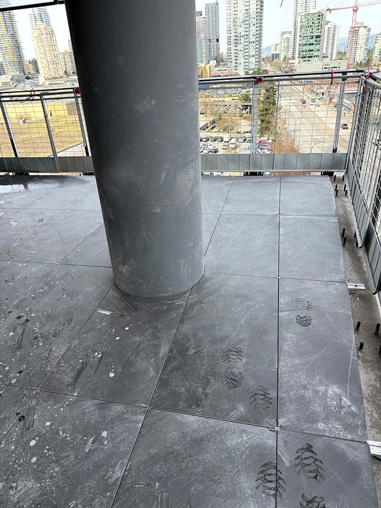 Balcony tile precision cuts around structural column Concord Metrotown Burnaby