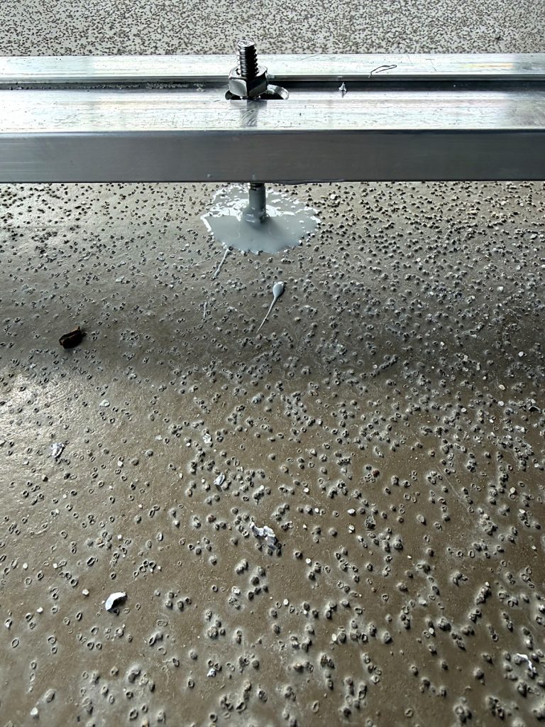Sealed anchor bolt in waterproofed balcony slab Burnaby BC