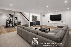 Renovated modern basement living space by Craft Master Luxe Construction